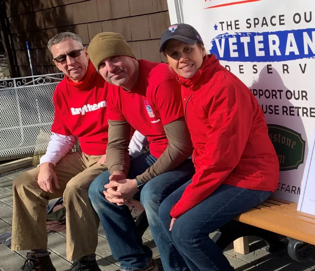 From left, Charlie Orosz, Brendan Hamm, and Samantha Sullivan take a break while working on the Retreat Center in 2021