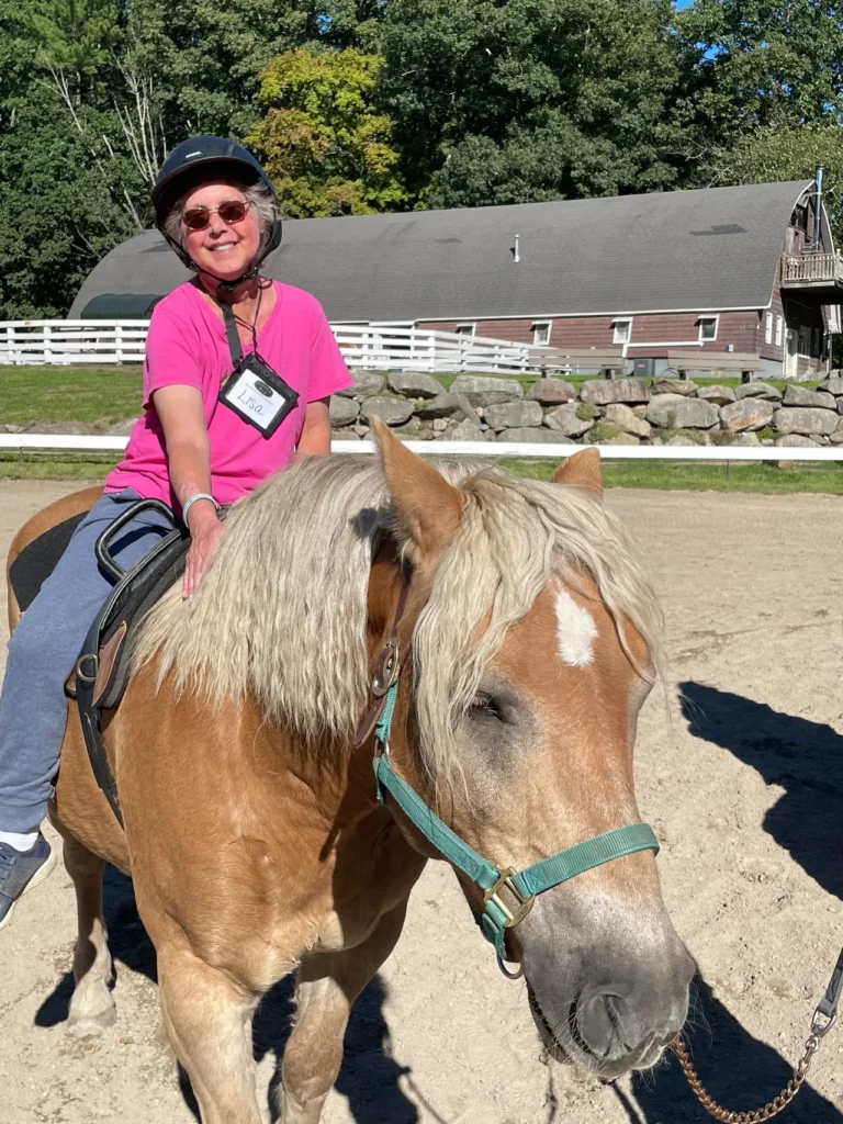 Lisa smiles atop Dunnie the horse