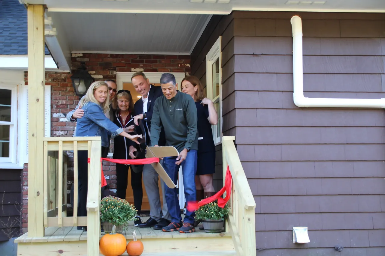 Executive Director Kerri Whalen (right), and Challenge Unlimited founder Deedee O'Brien (third from left) join volunteers (from left) Samantha Sullivan and Charlie Orosz, and board members Brendan Hamm and Ralph Acaba for the ribbon cutting ceremony at the grand opening of the Retreat Center